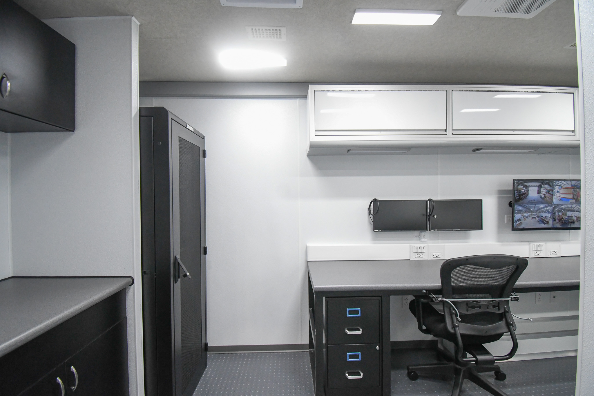 A view of the kitchenette, electrical rack cabinet, and workshop inside the unit for Albermarle, NC.