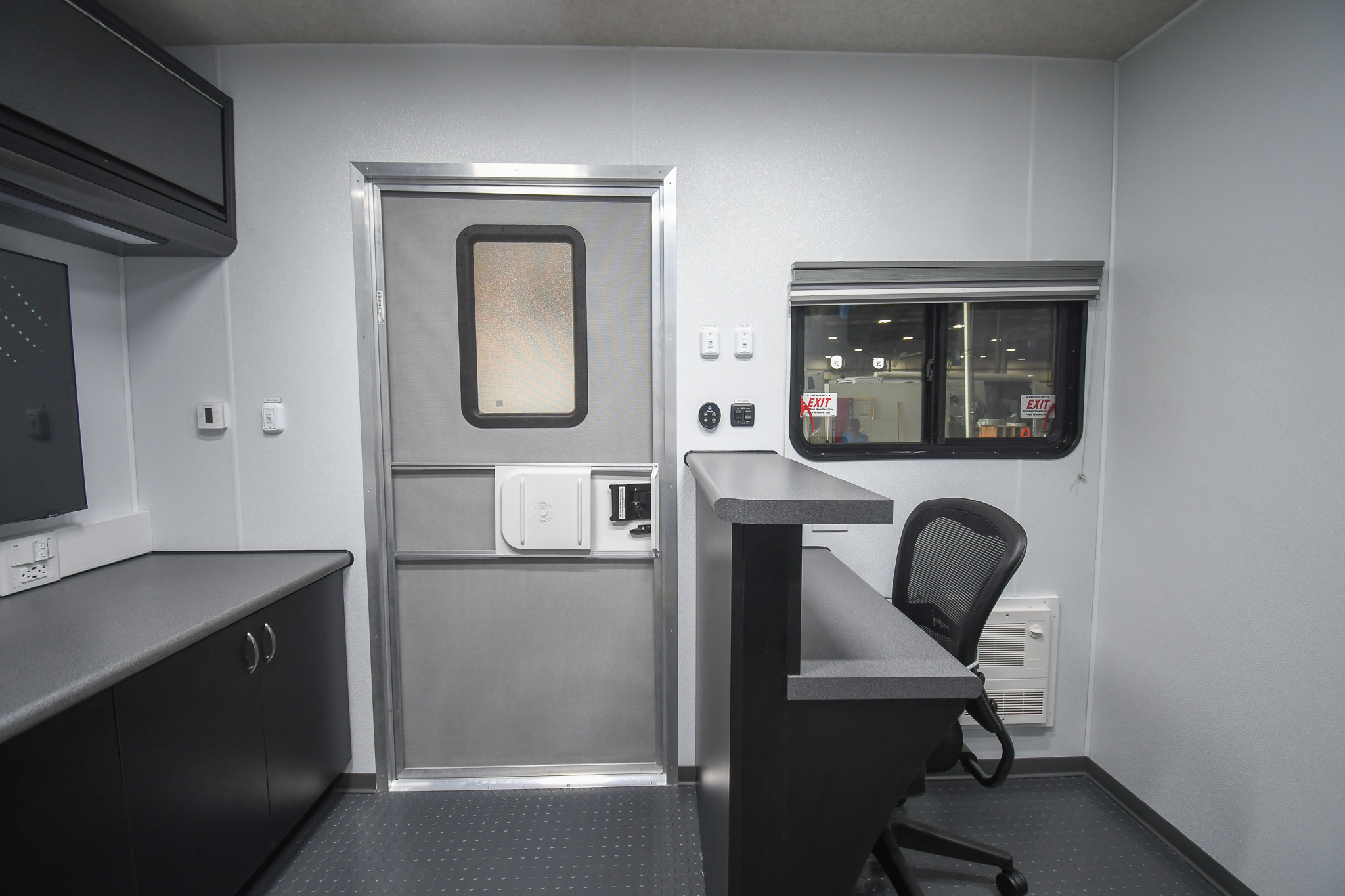 A view of the receptionist desk and TV inside the unit for Rosebud, SD.