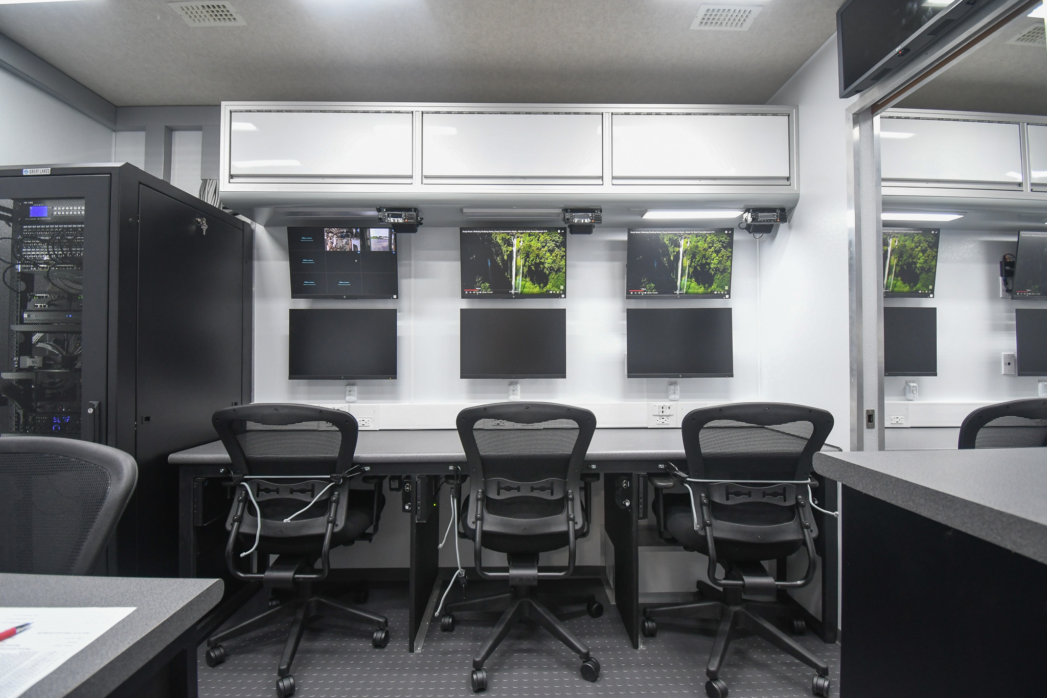 A full view of three workstations and the electronics rack inside the unit for Bartlett, TN. The fourth workstation is partially seen.