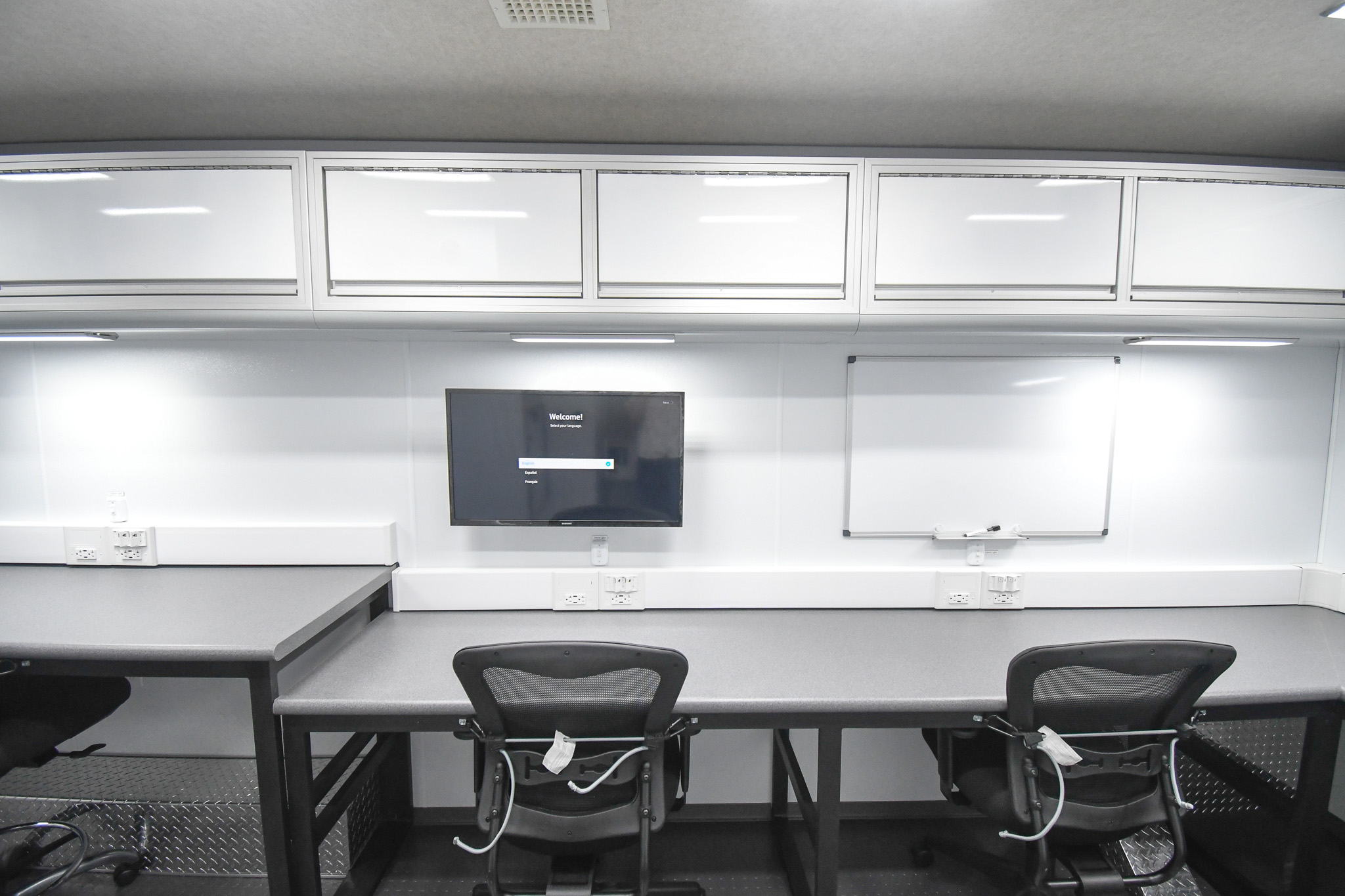 A full view of two workstations and a partial view of the third inside the unit for Kykostmovi, AZ.