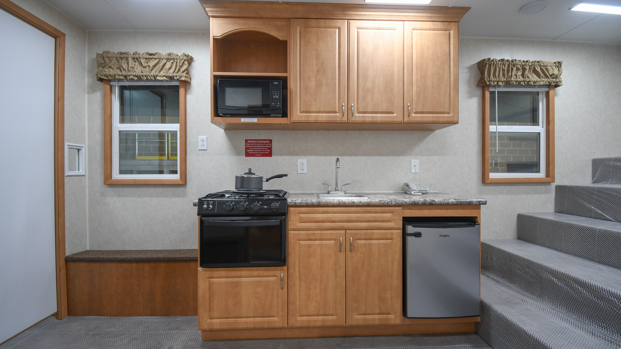 A partial view of the bleacher seating and full view of the kitchen stage inside the unit for Innisfil, ON.