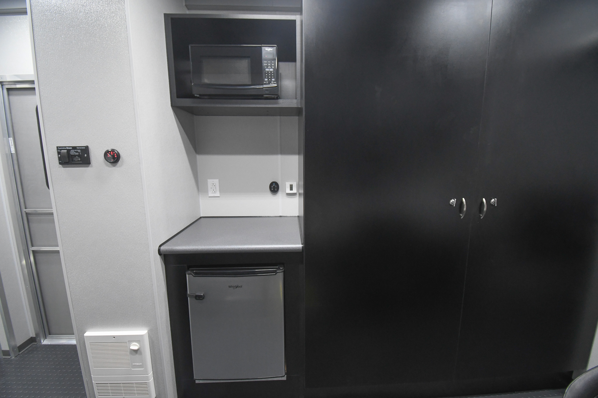 A view of the cabinet, refrigerator, and microwave inside the unit for Mechanicsburg, PA.