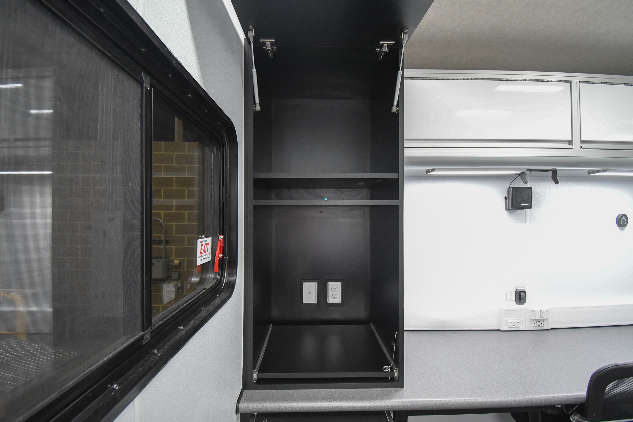 A closer look at the custom storage cabinet inside the unit for Winchester, VA. It's meant to hold a printer.