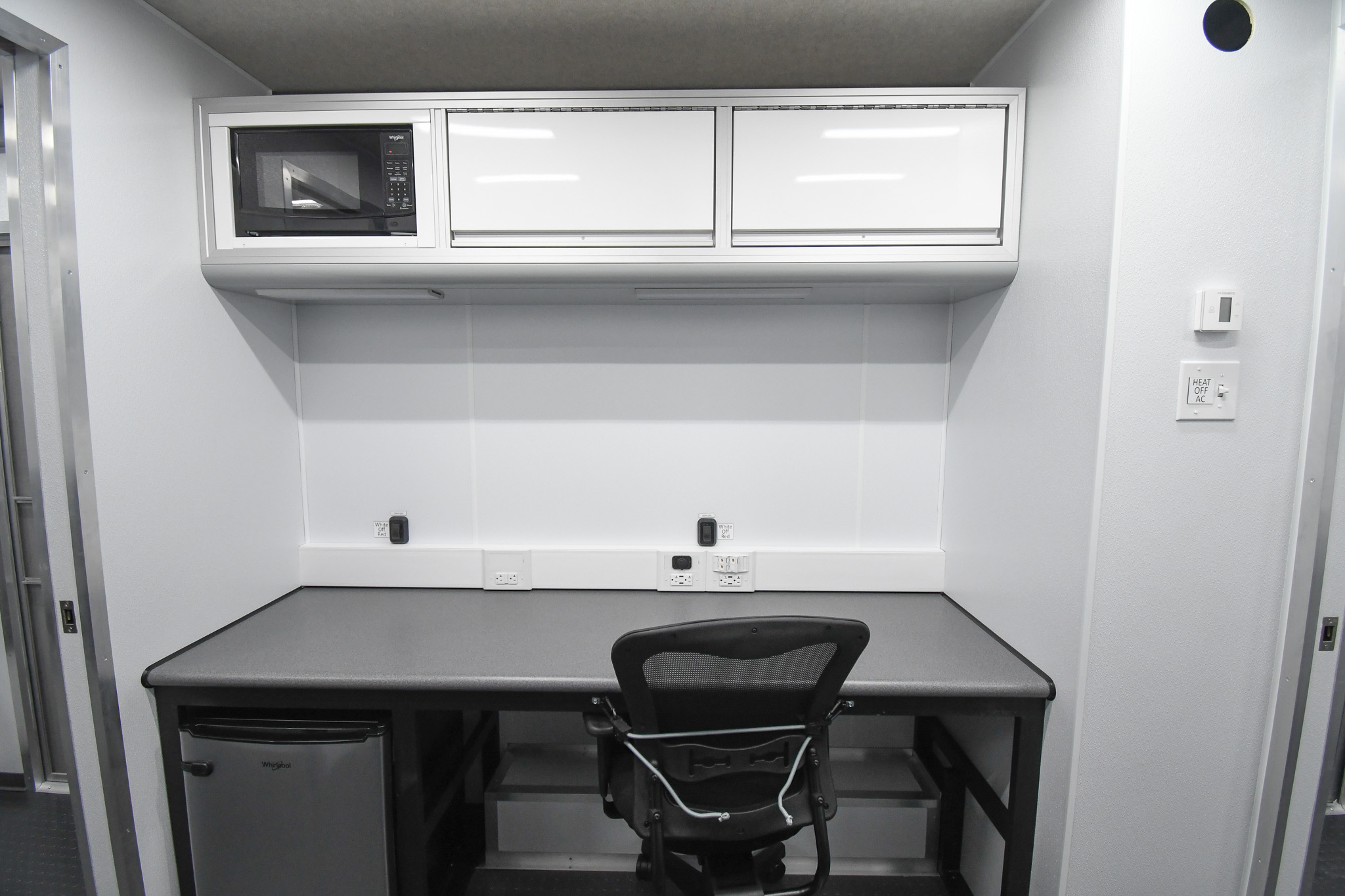 A workstation, refrigerator, and microwave inside the unit for Columbiana, OH.