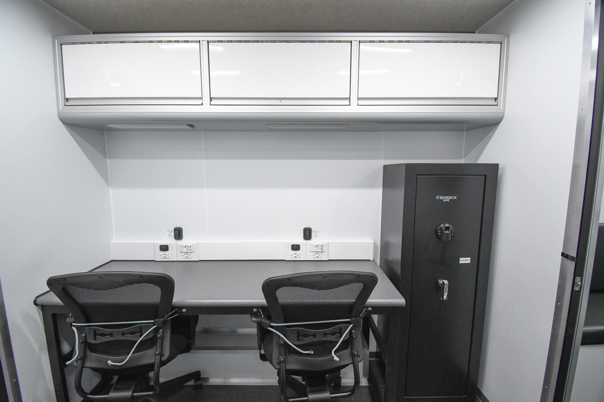 Two workstations and the lockable gun closet inside the unit for Columbiana, OH.